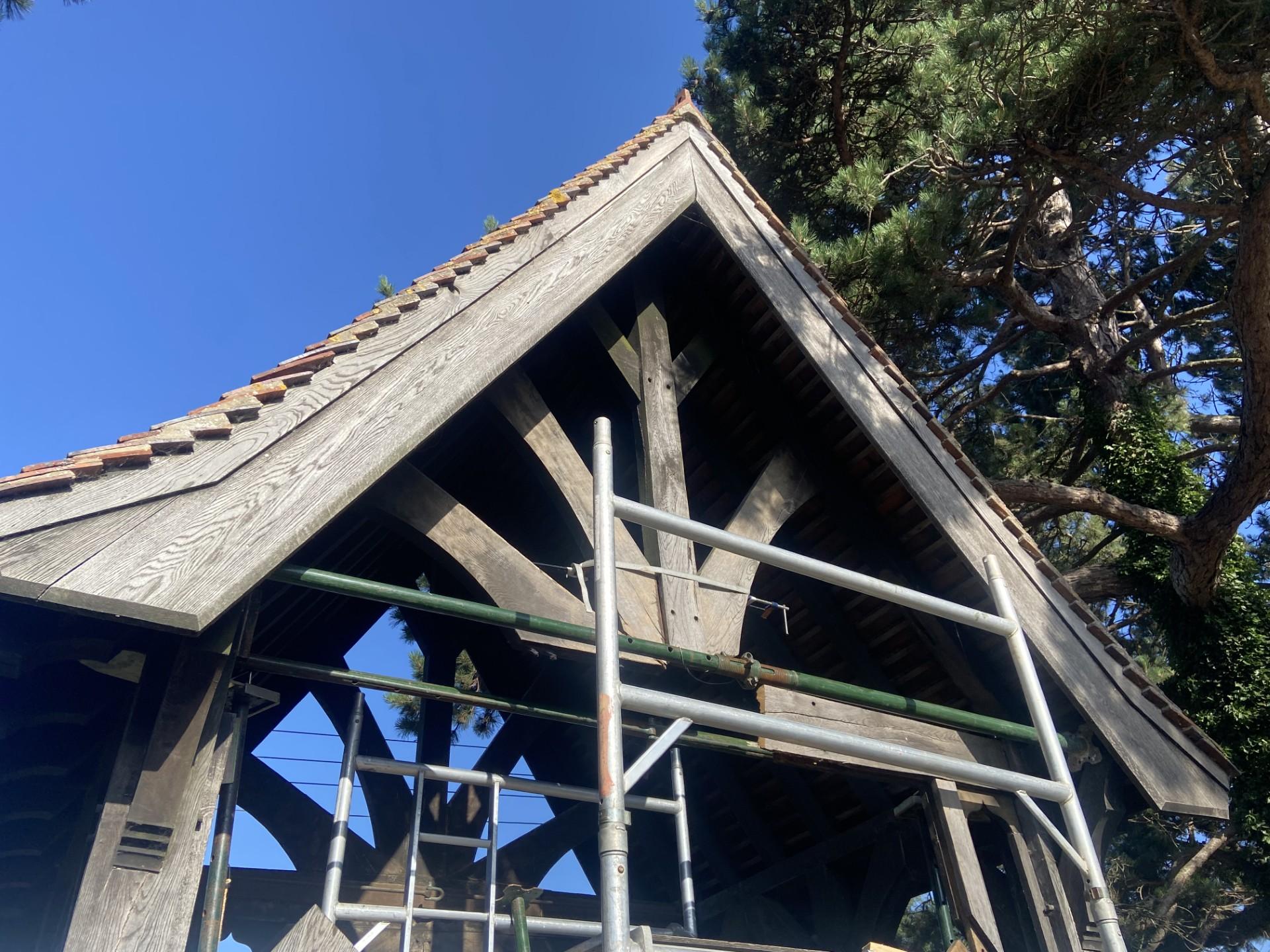 1. A wooden building under construction, surrounded by scaffolding for support and access.