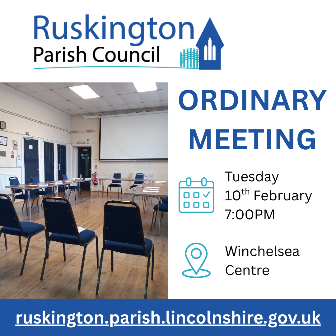 A formal meeting in Lincolnshire, showing participants engaged in discussion with papers and digital devices present.