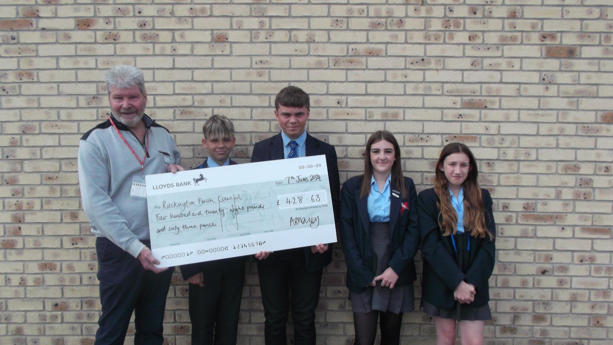 St georges cheque presentation with pupils and parish council chairman